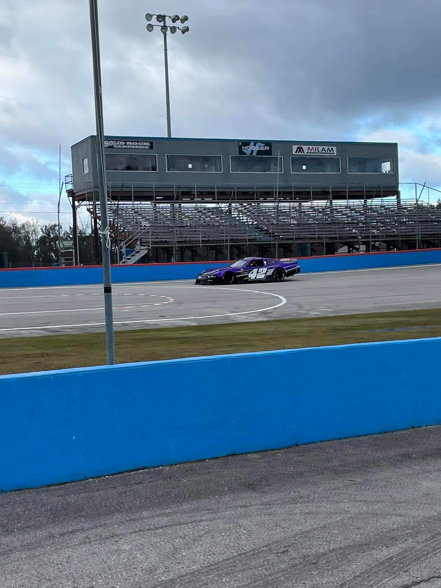 The purple #42 rolling past the grandstand at Langley Speedway