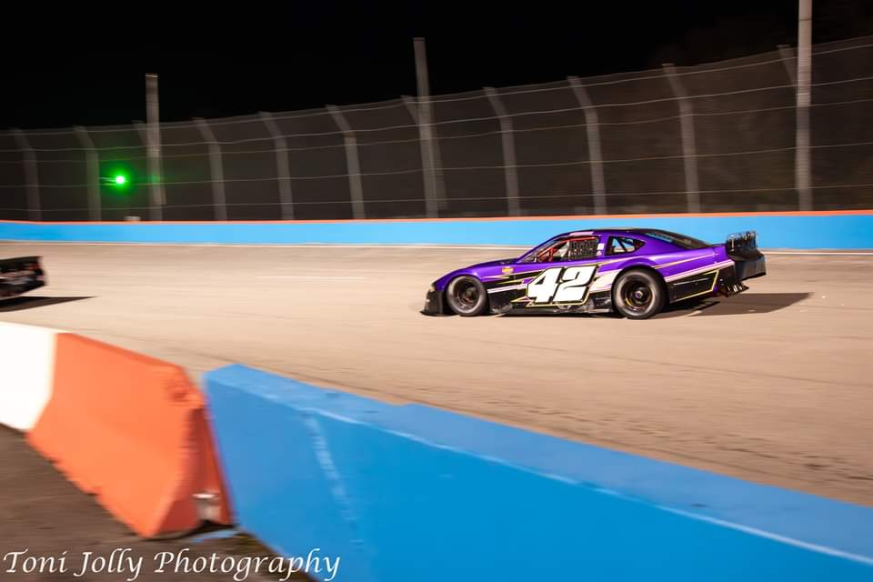 The purple #42 racing under the lights