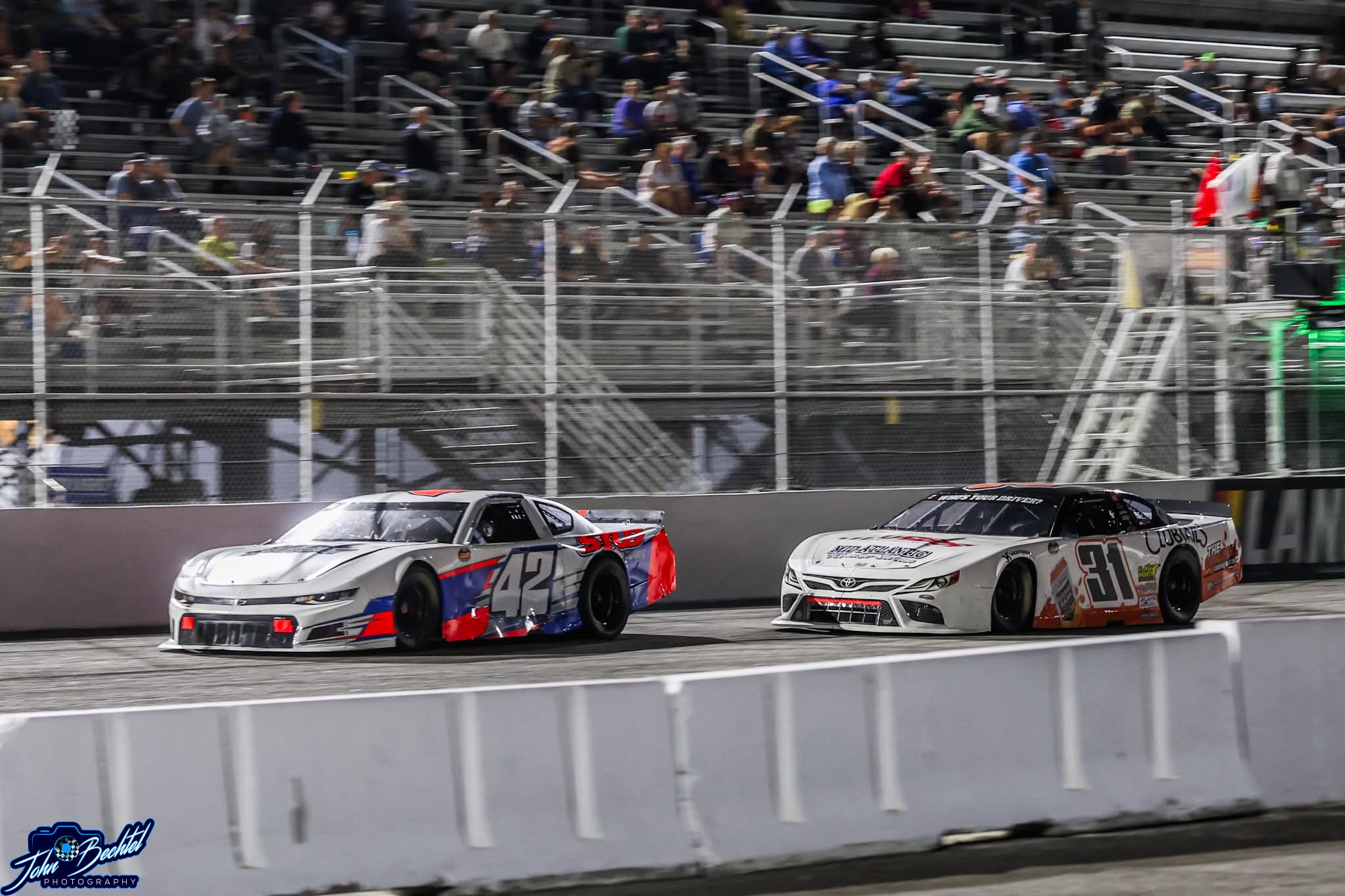 The #42 racing side by side with the #31 under the lights