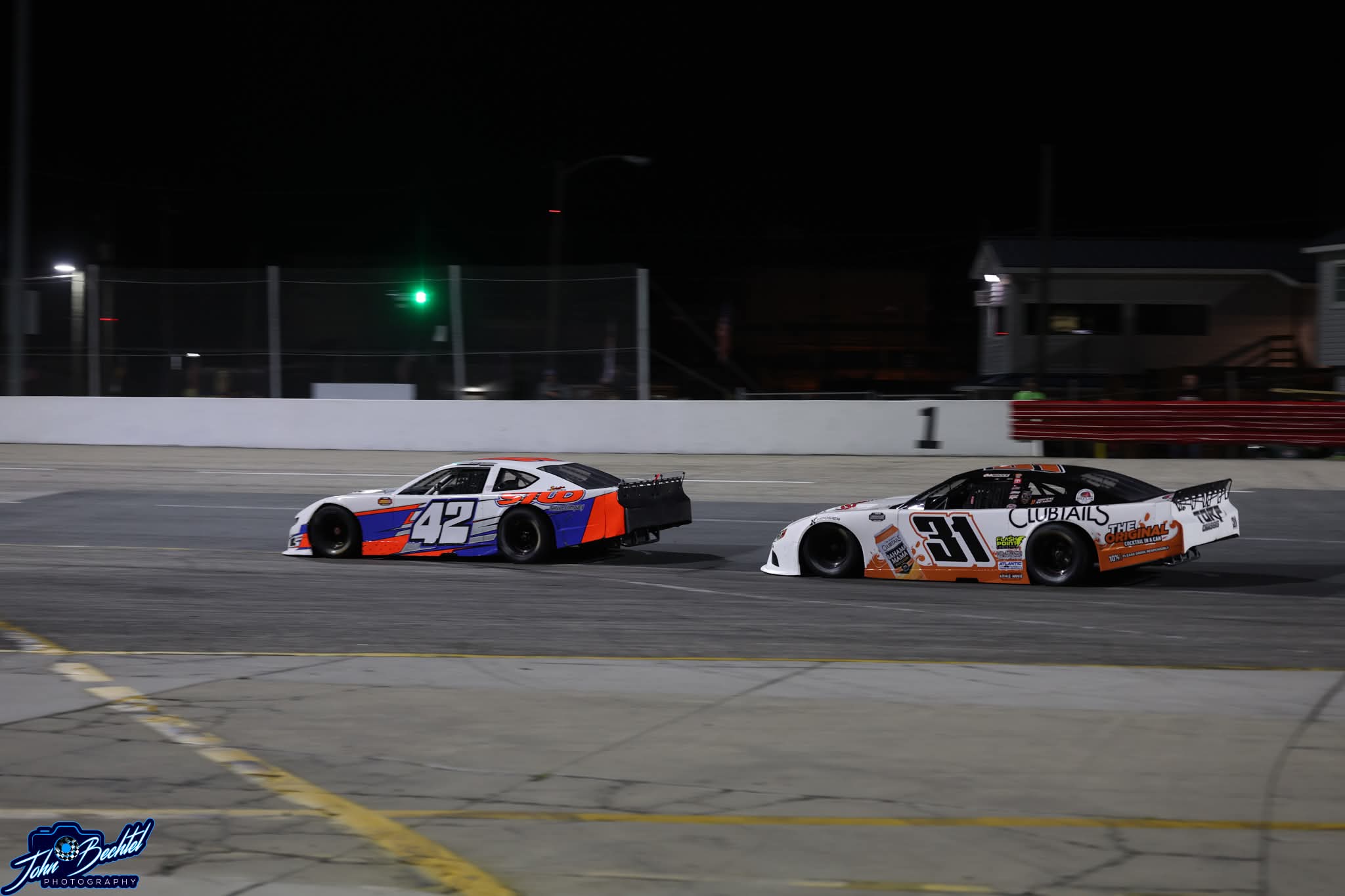 The #42 STUD car battling the #31 under the lights
